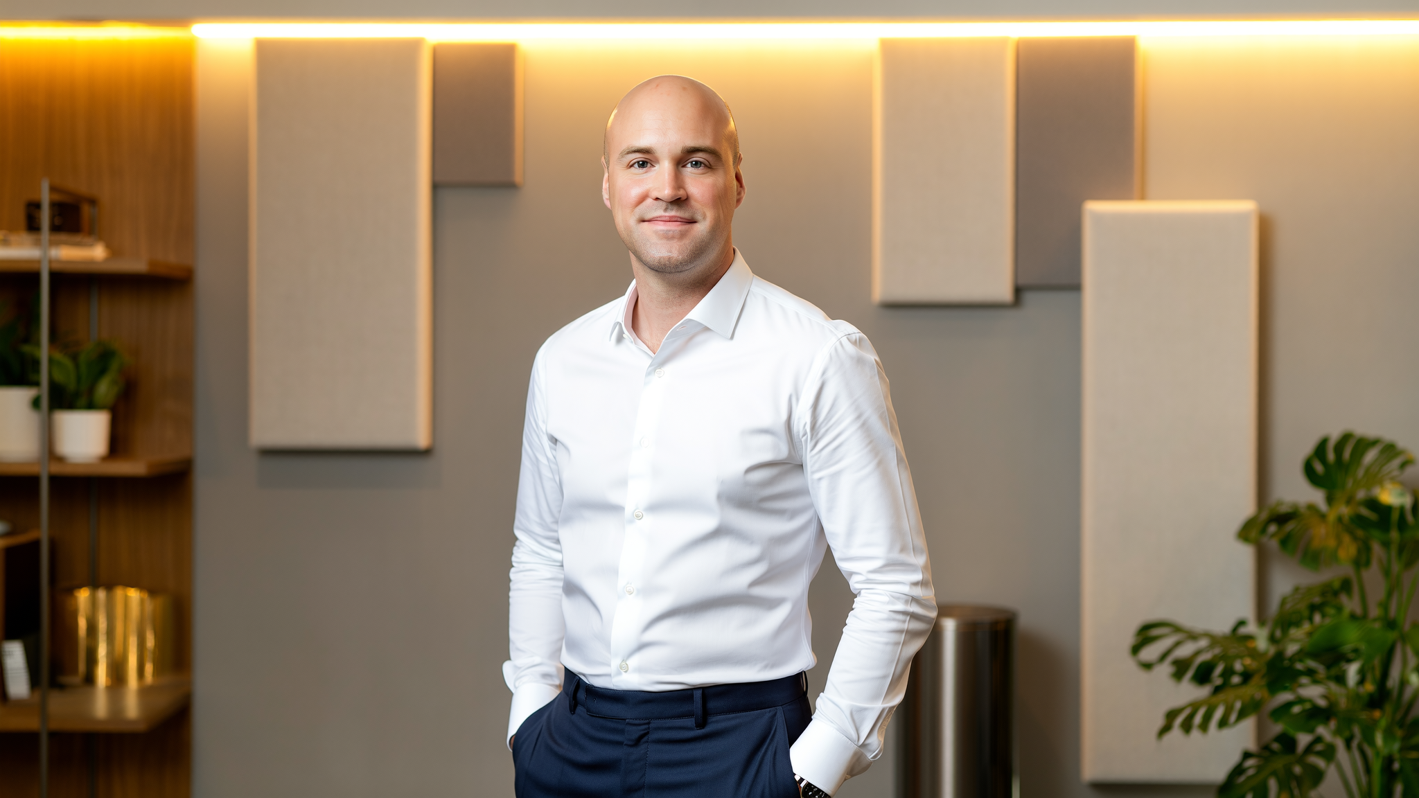 Jeremy Thomas standing in a studio portrait.